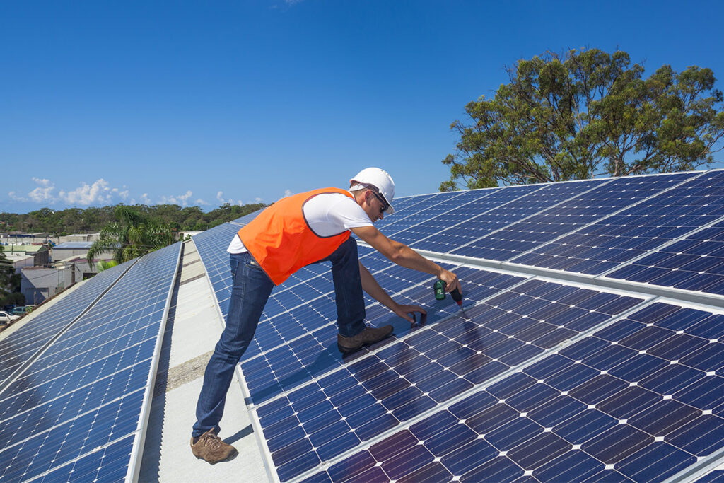 worker installing solar panels