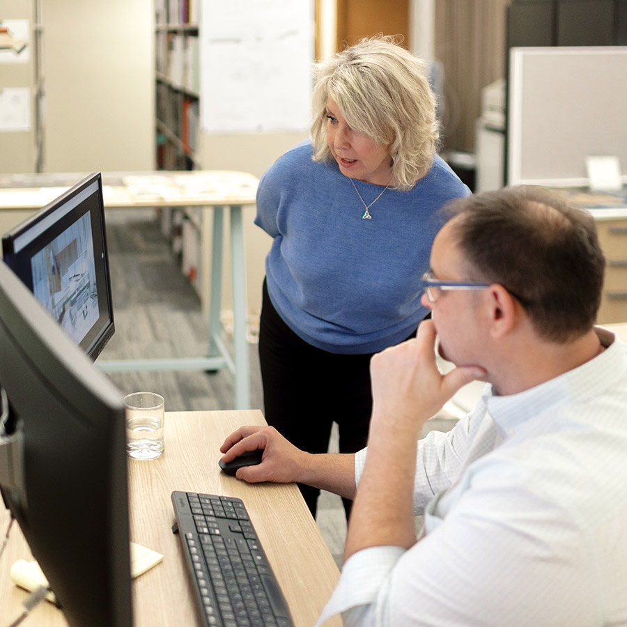 Bachmann team looking over a computer screen